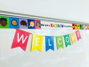 borders and welcome sign in esl classroom held by magnets on whiteboard