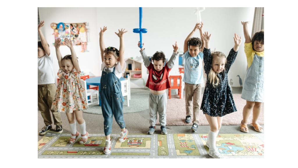 photo of children playing with hands raised during ESL listening games