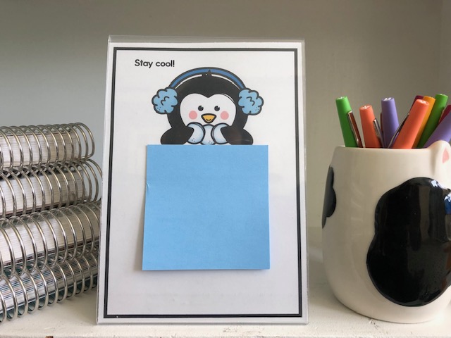 photo of a clear frame with penguin insert and sticky notes attached
