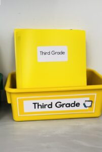 essential ESOL supplies: plastic bin with folders to organize student work and teacher papers