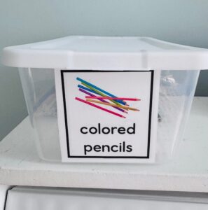 labeled bin with colored pencils for a newcomer-friendly classroom